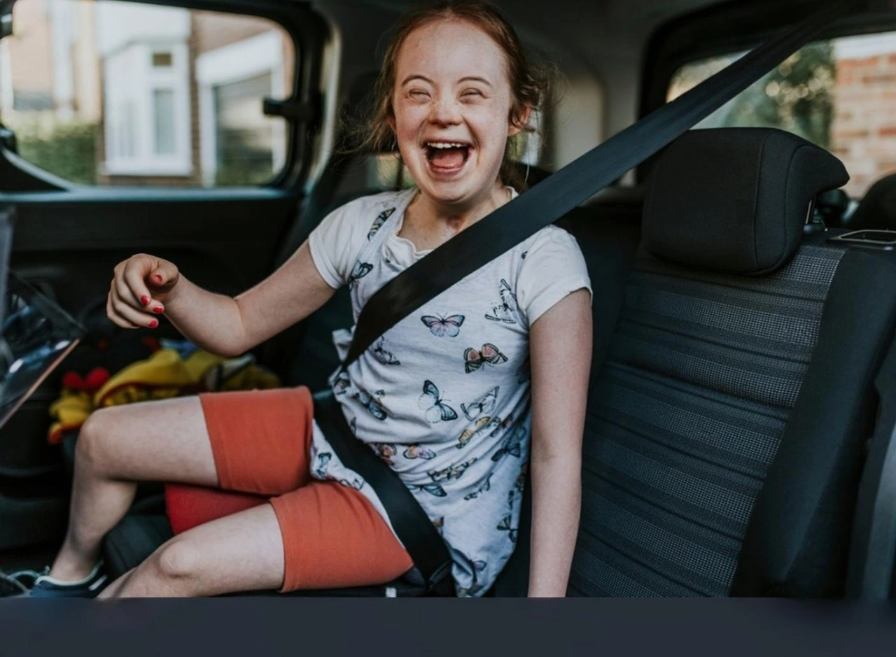 Disabled girl in car smiling