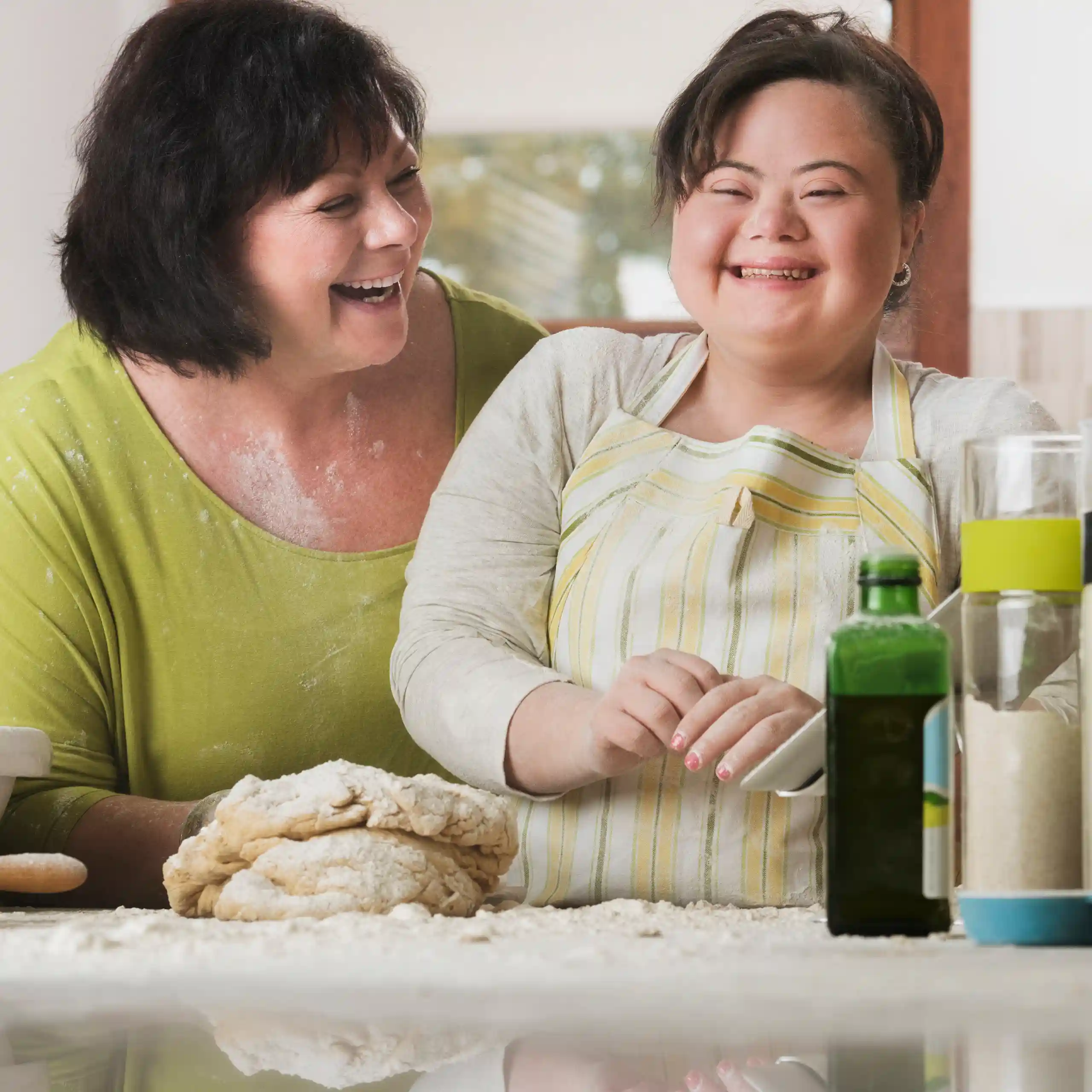 Support worker cooking with disabled girl